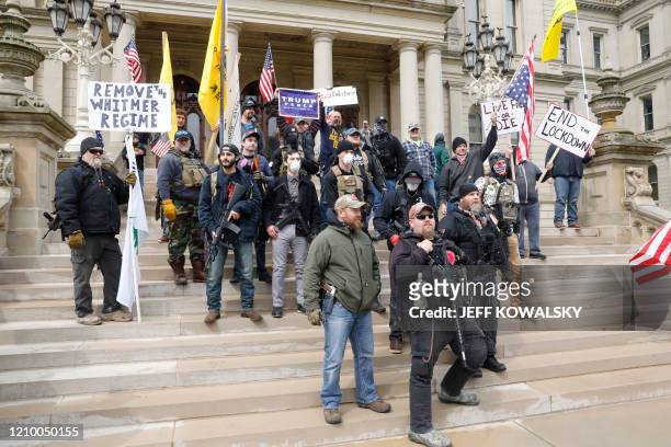 People take part in a protest for "Michiganders Against Excessive Quarantine" at the Michigan State Capitol in Lansing, Michigan on April 15, 2020. -...