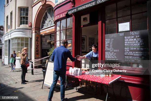 Customers observe social distancing outside Heap's Sausage Cafe serving take away on 15th April 2020 in Greenwich, London, United Kingdom. Chancellor...