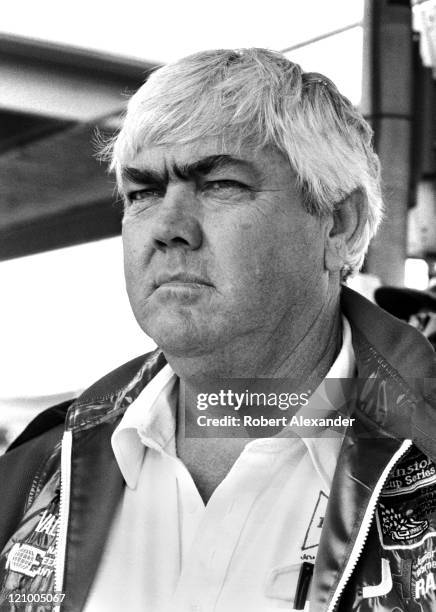 Car owner Junior Johnson watches from the pits at the Daytona International Speedway as cars qualify for the 1983 Daytona 500 on February 19, 1983 in...