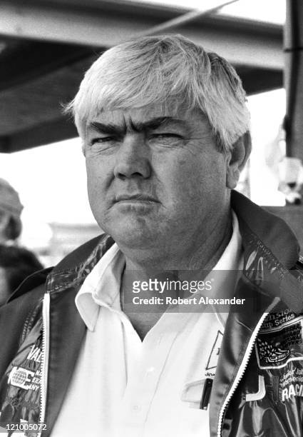 Car owner Junior Johnson watches from the pits at the Daytona International Speedway as cars qualify for the 1983 Daytona 500 on February 19, 1983 in...