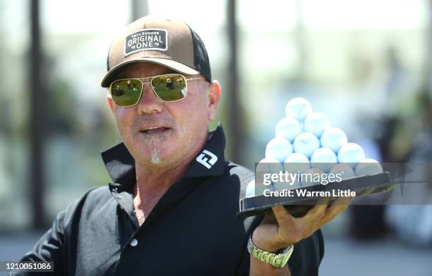 Caddie Kyle Roadley fetches some practice golf balls on the range ahead of the Commercial Bank Qatar Masters at Education City Golf Club on March 03,...