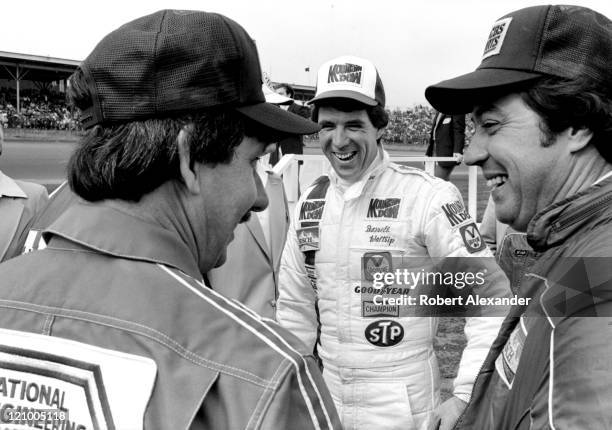Driver Darrell Waltrip talks with fellow race drivers Neil Bonnett and Harry Gant prior to the start of the 1982 Daytona 500 on February 14, 1982 at...
