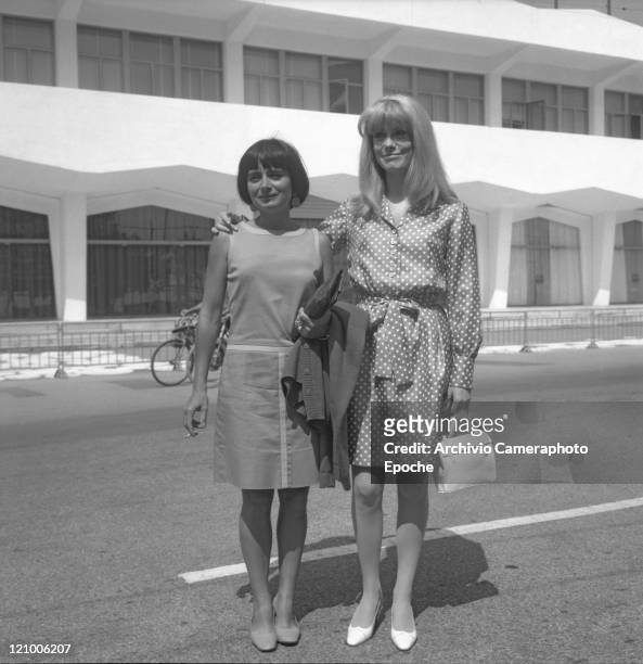 French actress Catherine Deneuve, wearing a polka-dotted dress, portrayed while standing in front of the Movie Festival building with the director...