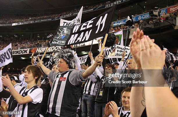 Members of the Collingwood cheer squad show their support during the round 21 AFL match between the St Kilda Saints and the Collingwood Magpies at...