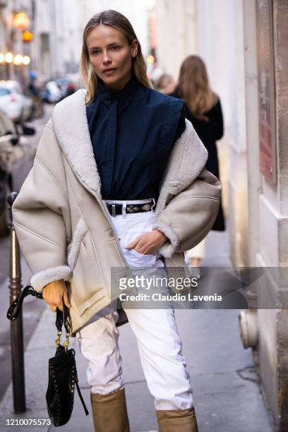 Natasha Poly, wearing a blue shirt, white jeans and beige jacket, is seen outside Isabel Marant, during Paris Fashion Week - Womenswear Fall/Winter...