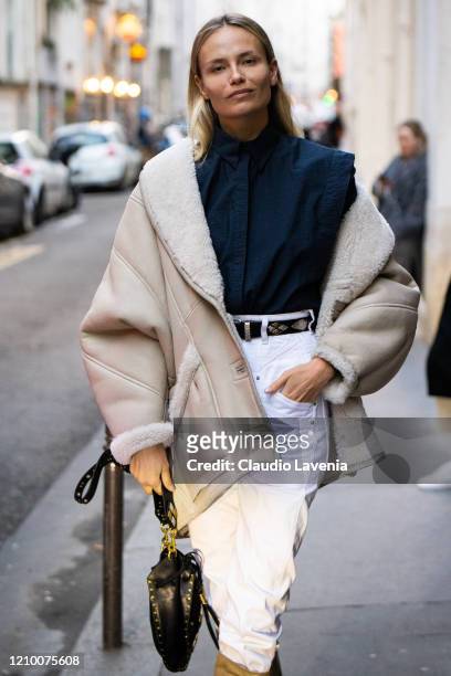 Natasha Poly, wearing a blue shirt, white jeans and beige jacket, is seen outside Isabel Marant, during Paris Fashion Week - Womenswear Fall/Winter...
