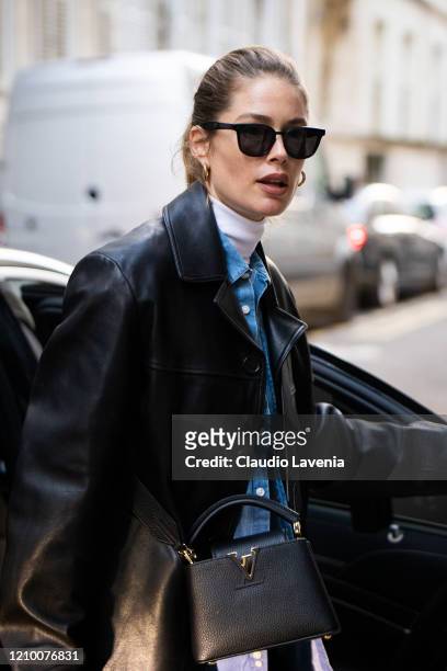 Doutzen Kroes, wearing a white turtleneck top, denim shirt, black leather blazer and black Louis Vuitton bag, is seen outside Isabel Marant, during...