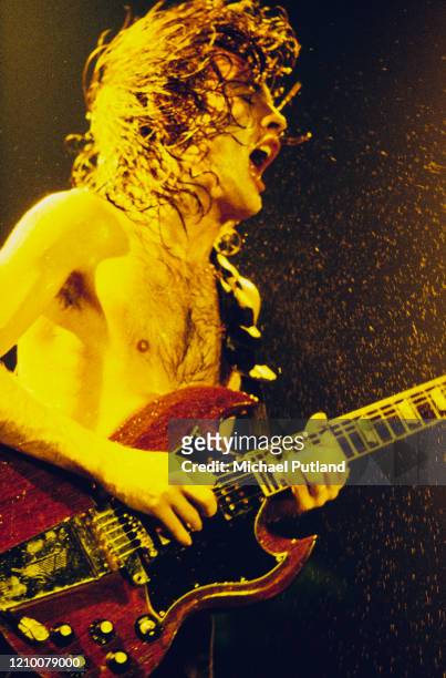Australian guitarist Angus Young performs live on stage with heavy rock group AC/DC in London during the band's Back In Black Tour in November 1980.