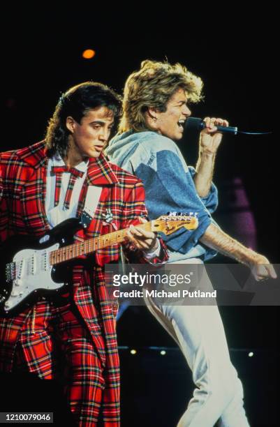 George Michael and Andrew Ridgeley of Wham! performing together live on stage during the pop duo's 1985 world tour, January 1985. 'The Big Tour' took...