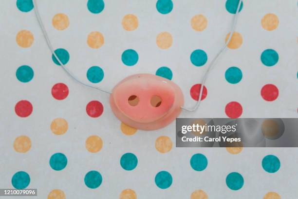 plastic carnival pig nose in polka dots background - nose mask stock pictures, royalty-free photos & images