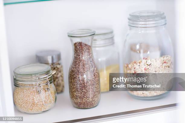 Symbol photo unpackaged food. Storage jars with cereals and seeds are placed in a kitchen cupboard on April 11, 2020 in Berlin, Germany.