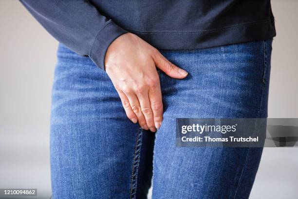 Symbol image venereal disease or bladder weakness. A woman grabs her crotch with her hand on April 13, 2020 in Berlin, Germany.