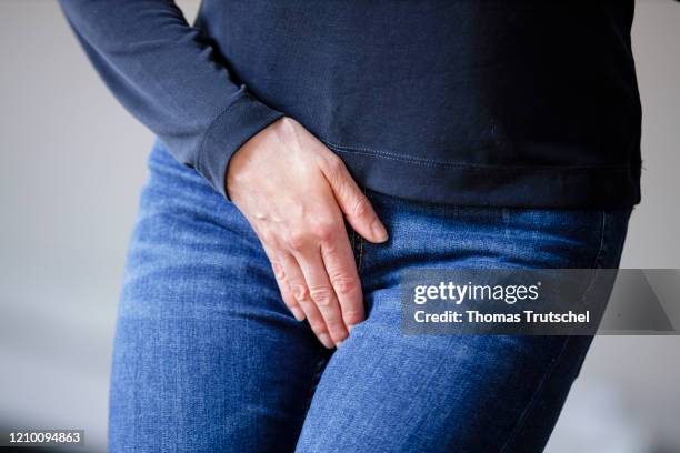 Symbol image venereal disease or bladder weakness. A woman grabs her crotch with her hand on April 13, 2020 in Berlin, Germany.