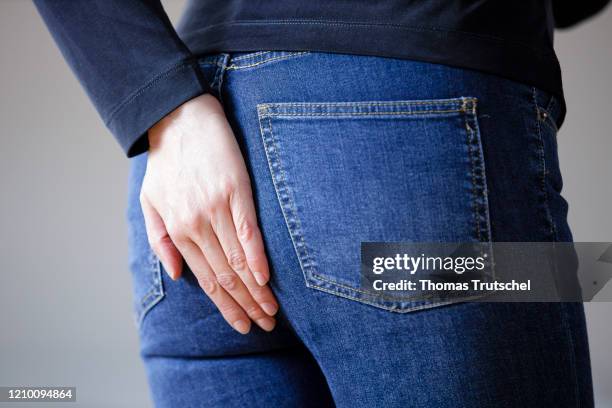 Symbol picture diarrhoea and flatulence. A woman grabs her buttocks with her hand on April 13, 2020 in Berlin, Germany.