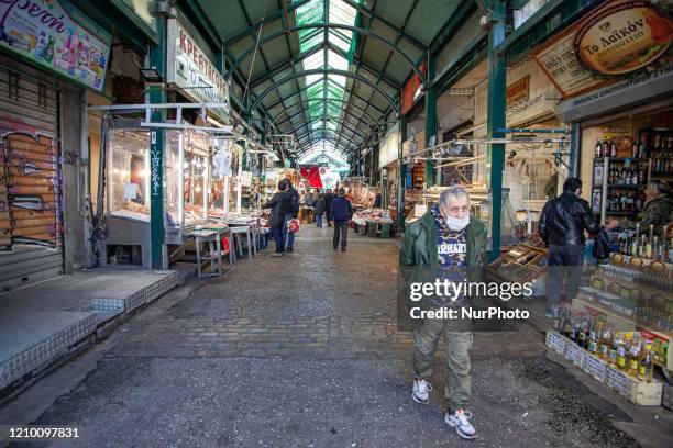 Consumers are seen with protective face mask and gloves during the lockdown in the historic and largest public open central market in the heart of...