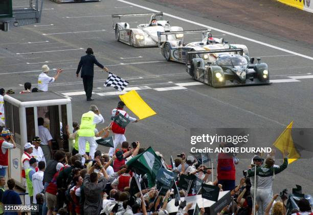 The Bentley N·7 driven by British Guy Smith, Danish Tom Kristensen and Italian Rinaldo Capello, crosses the finish line ahead of The Audi R8 driven...