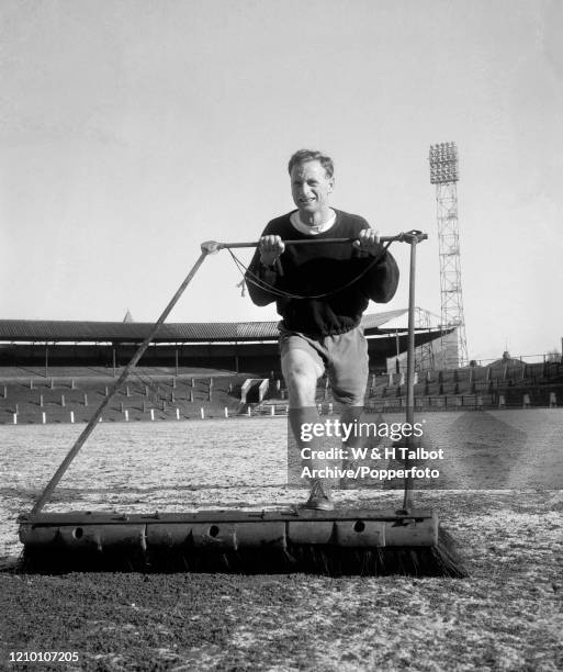 Tom Finney of Preston North End clearing snow from the pitch at Deepdale in Preston, England, circa March 1960.