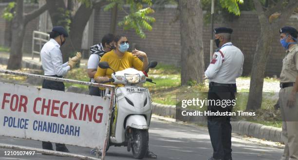 Police personel fine commuters out during the lockdown against coronavirus, at the Sector 41-42 dividing road on April 16, 2020 in Chandigarh, India.