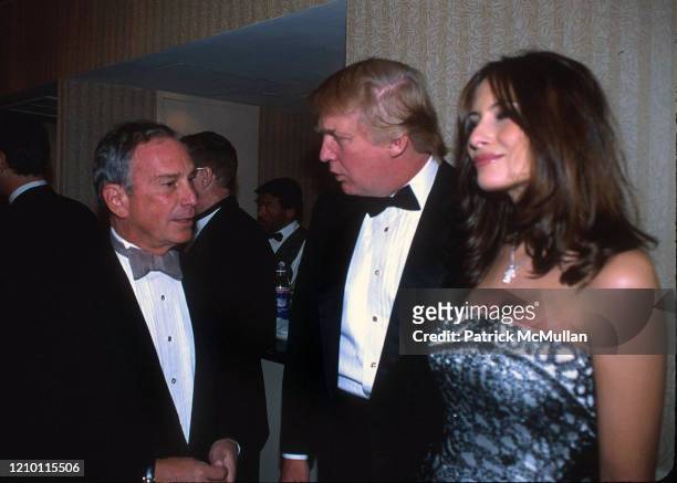Portrait of, from left, New York City Mayor Michael Bloomberg, Donald Trump, and Melania Knauss as they attend at pre-dinner party for the White...