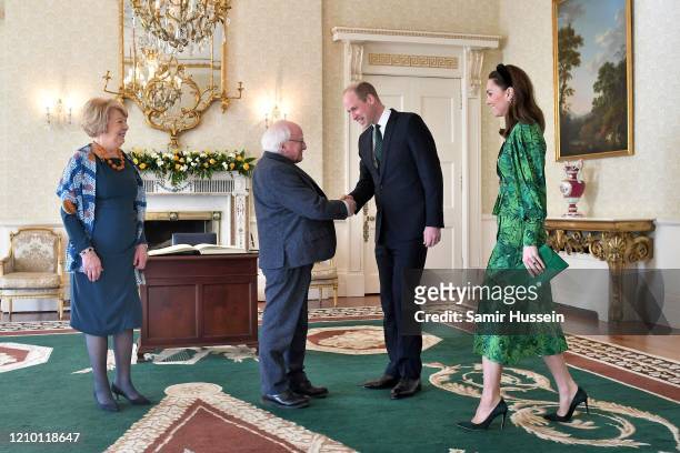 Prince William, Duke of Cambridge and Catherine, Duchess of Cambridge are greeted by the President of Ireland Michael D. Higgins and his wife Sabina...