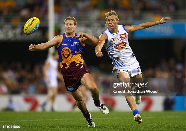 Luke Power of the Lions and Matt Shaw of the Suns contest the ball during the round 21 AFL match between the Brisbane Lions and the Gold Coast Suns...