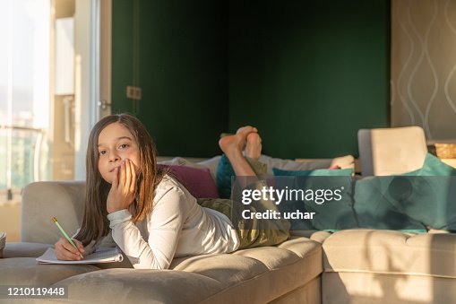 Homework Stack Image Little Girl Doing Homework At Home High-Res Stock Photo - Getty Images