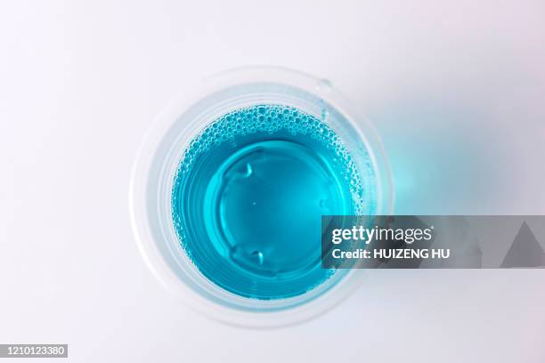 a cup of mouthwash - mundspülung stock-fotos und bilder