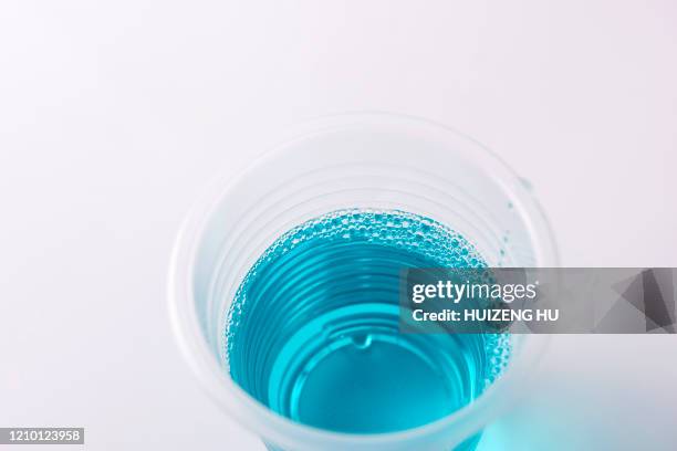 a cup of mouthwash - mundspülung stock-fotos und bilder