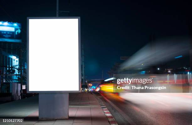 blank billboard on city street at night. outdoor advertising - city light poster stock pictures, royalty-free photos & images