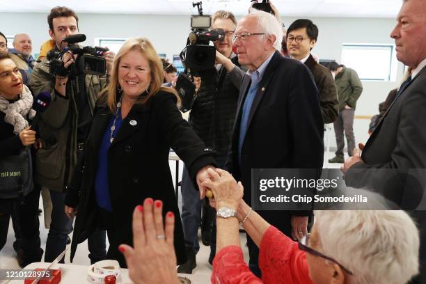 Democratic presidential candidate Sen. Bernie Sanders and his wife Jane O'Meara Sanders say goodbye to poll workers after voting in their state's...