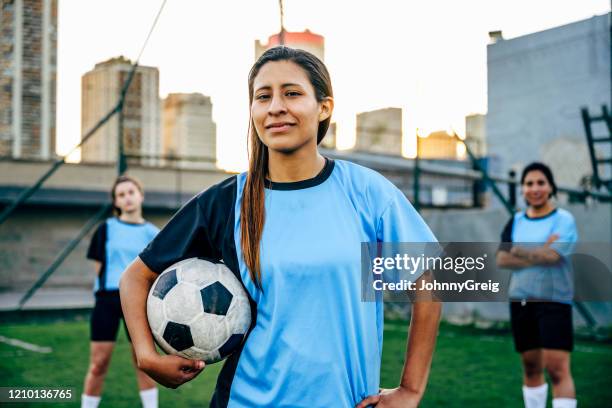 confident young hispanic footballer identifying as non-binary - argentina soccer imagens e fotografias de stock