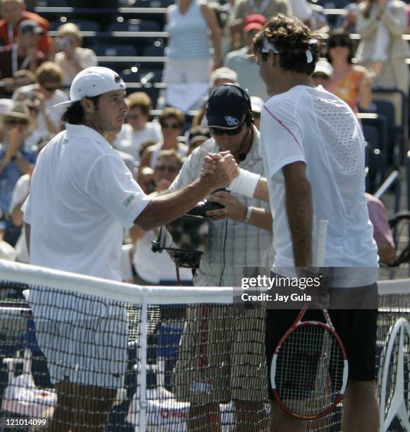 Top seeded Roger Federer of Switzerland shakes hands with Sebastien Grosjean of France after his 2nd round match in the Rogers Cup at the Rexall...