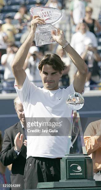 No.1 seed Roger Federer raises the winners trophy after defeating Richard Gasquet of France in the final of the Rogers Cup ATP Master Series tennis...