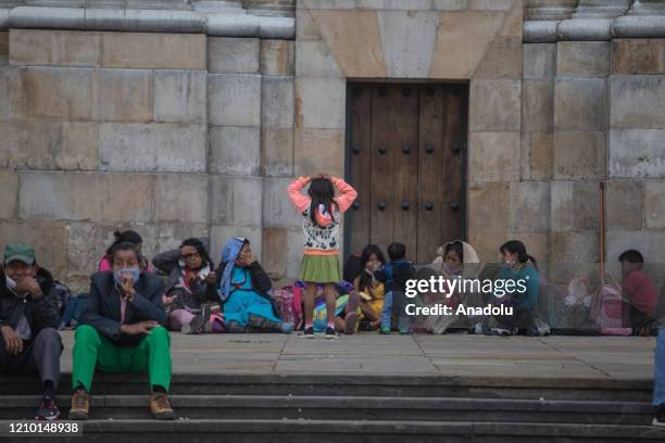 Embera Indigenous families with their children are seen at the Bolivar Square in Bogota, Colombia on April 16, 2020. The struggle of the Embera...
