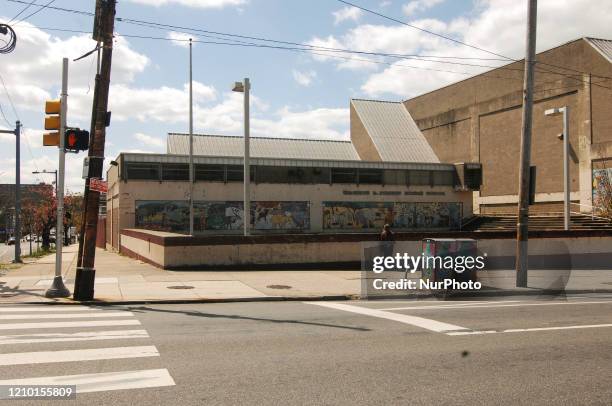 Mentally ill homeless woman stands alone in front of a closed middle school the adult daycare facility she would have usually gone to each day...