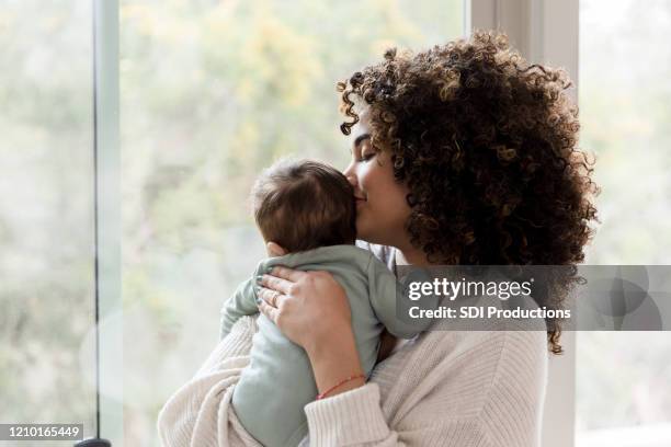 mom spends time with baby boy - beautiful latina women stock pictures, royalty-free photos & images