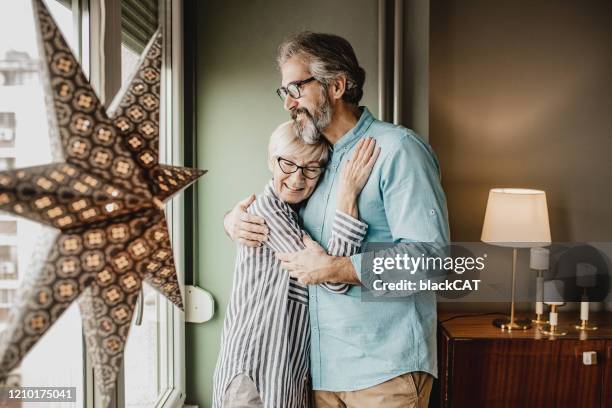 senior couple having a romantic moment at home - carefree moment stock pictures, royalty-free photos & images