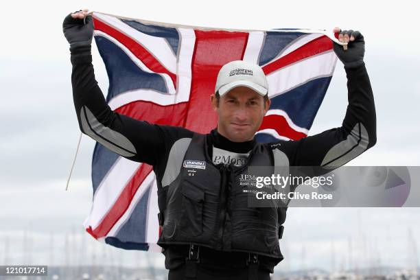 Ben Ainslie of Great Britain celebrates on shore after winning the Mens Finn class medal race on day twelve of the Weymouth and Portland...