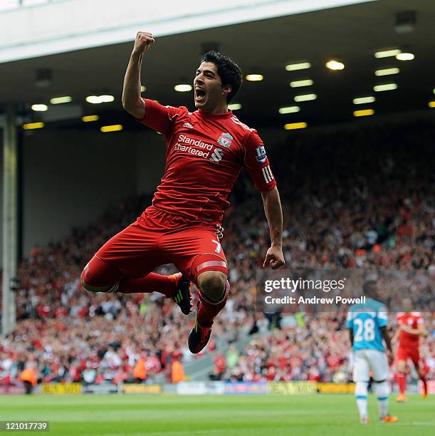 Luis Suarez of Liverpool celebrates scoring his team's opening goal during the Barclays Premier League match between Liverpool and Sunderland at...