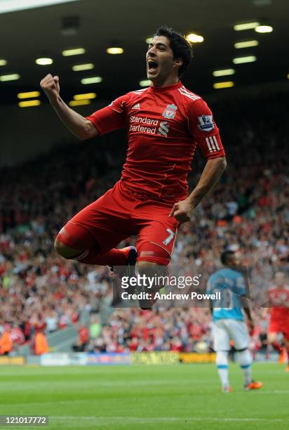 Luis Suarez of Liverpool celebrates scoring his team's opening goal during the Barclays Premier League match between Liverpool and Sunderland at...
