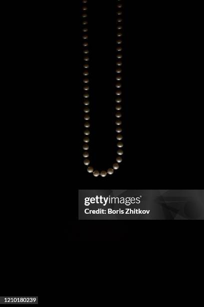 pearl beads over dark background. - bead necklace stock pictures, royalty-free photos & images