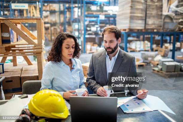 business people checking list and inventory on laptop at warehouse - businessman working on a laptop with a coffee stock pictures, royalty-free photos & images