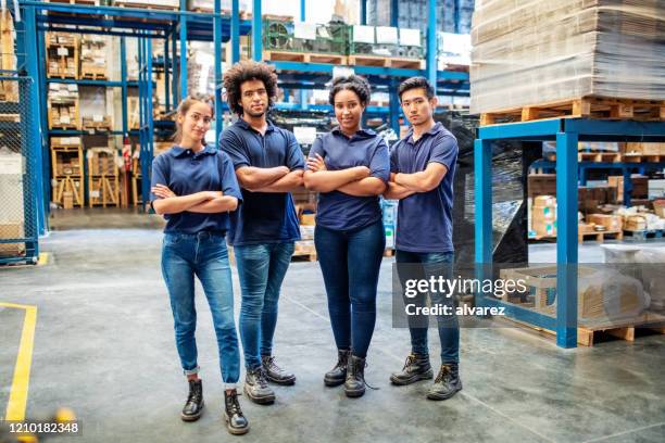group portrait of staff at distribution warehouse - blue collar workers group stock pictures, royalty-free photos & images