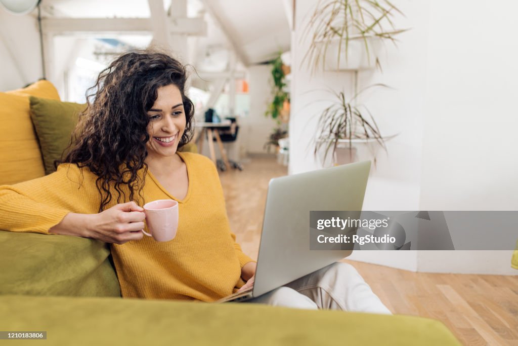 Beautiful woman freelancing from her living room