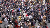 Coronavirus particles spreading in a crowd of people.