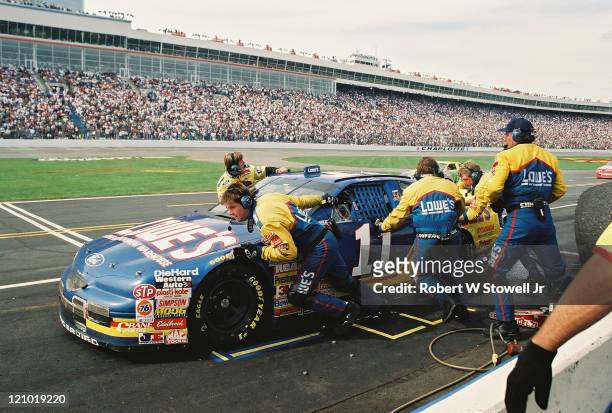 Bret Bodines drives the Lowes car while his pit crew finishes servicing the racecar during a pitstop, Charlotte, North Carolina, 1997.