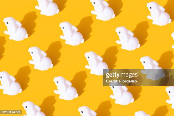 white bunny on yellow background. festive easter layout - bunny eggs stock-fotos und bilder