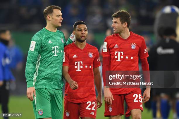 Manuel Neuer, Serge Gnabry and Thomas Mueller of Bayern Munich celebrate at the end of the DFB Cup quarterfinal match between FC Schalke 04 and FC...