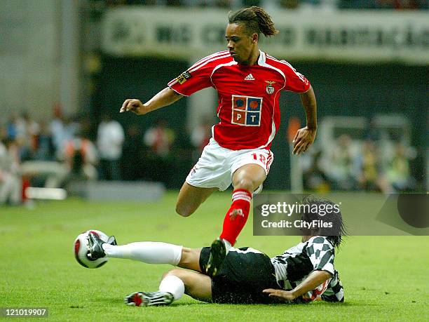 Manu of Benfica and Mario Silva of Boavista. Benfica suffered one heavy defeat in its start of the Portuguese Soccer League, losing for 3-0 against...