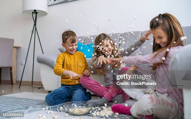 popcorn fight! - kid throwing stock pictures, royalty-free photos & images